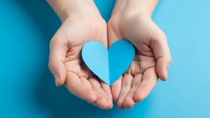 Fototapeta premium Show love with a blue heart in caring hands