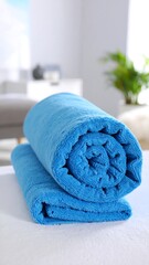 Rolled blue towel on a surface