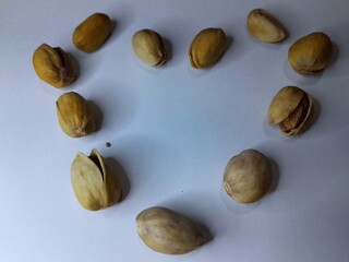 pistachio with love shape on white background 
