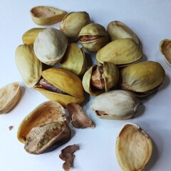 close up of roasted pistachios on a white background 