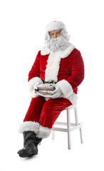 Santa Claus with letters sitting on white background