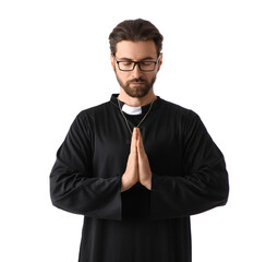 Handsome priest in eyeglasses praying on white background