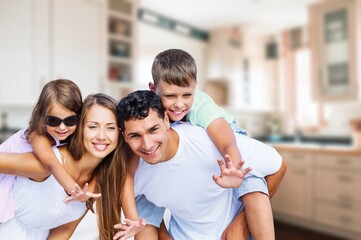 Happy young family and children in living room