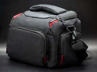 Generic black and red camera bag with shoulder strap, camera bag concept