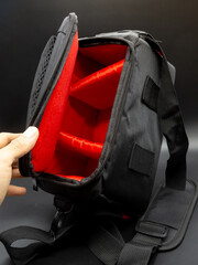 Generic black and red camera bag with shoulder strap, camera bag concept