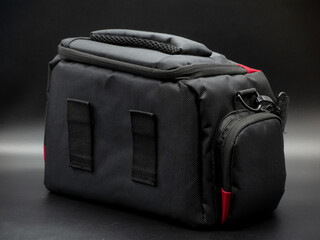 Generic black and red camera bag with shoulder strap, camera bag concept