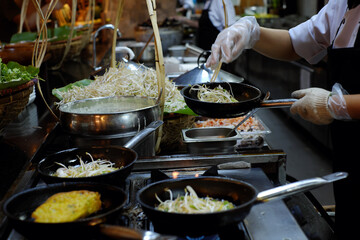 A chef is cooking Banh Xeo, a traditional Vietnamese food, at a resort buffet