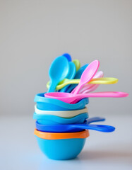 Stack of Colorful Plastic Measuring Spoons and Cups