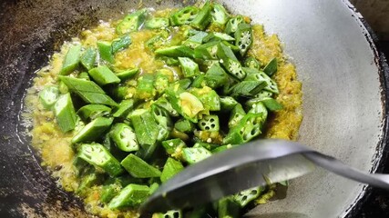Cooking okra curry in pan, indoor Chiangmai Thailand.
