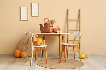 Interior of dining room with table, ladder and pumpkins