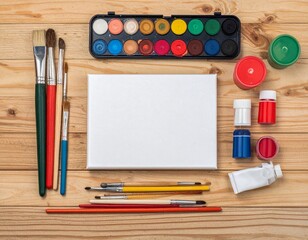 Naklejka premium Artistic setup with blank canvas, brushes, and paints on a wooden table