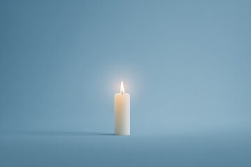Single white candle burning in minimalistic blue setting with soft shadows