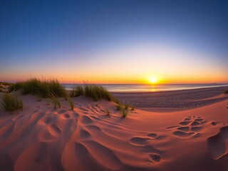 Fototapeta premium Serene beach sunset panorama with vibrant orange and blue sky over the ocean