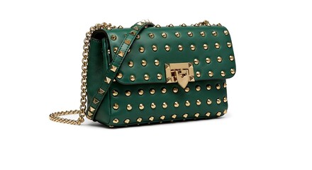 Obraz premium Emerald Green Studded Handbag with Gold Chain and Hardware on White Background