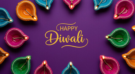 Colorful diwali lamps arranged around happy diwali text on a purple background top down view