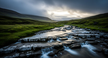 Dramatic moody sky over a rocky mountain stream flowing through lush green grassy hills in scotland