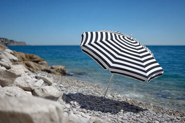 Striking monochrome parasol on a picturesque pebble beach overlooking tranquil ocean
