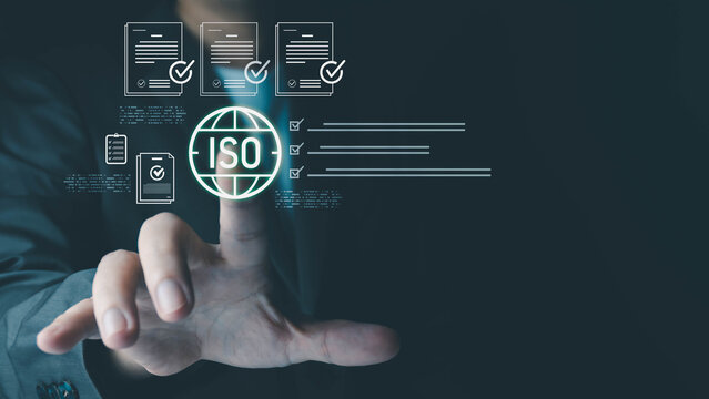 A person in a suit is interacting with a glowing "ISO" icon, surrounded by digital documents and checkboxes, symbolizing quality management and certification.
