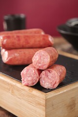 Raw Sausages on Volcanic Rock Slate Board Ready for Cooking