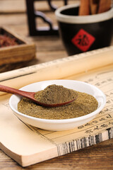 Ground Cumin Spice Powder in Bowl with Wooden Spoon - Traditional Cooking Ingredient for Barbecue and Seasoning