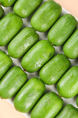 Fresh Green Mini Kiwi Fruits with Water Droplets on White Plate - Healthy Exotic Berry Snack