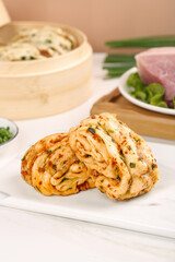 Homemade Steamed Scallion Pork Hand Rolls with Fresh Green Onions on White Plate