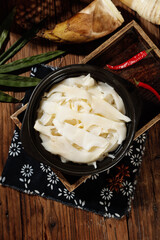 Freshly Dug Alpine Bamboo Shoots in Traditional Bowl with Asian Cooking Ingredients on Rustic Wood Table
