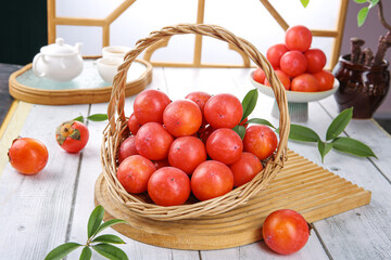 Fresh Red Persimmons in Wicker Basket - Natural Autumn Fruit Harvest Display on Rustic Wooden Table