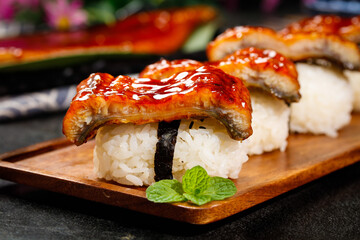 Grilled Eel Sushi Unagi Nigiri on Wooden Plate - Traditional Japanese Cuisine