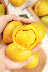 Fresh Yellow Fruits with Creamy Texture in Hands - Natural Organic Produce Cross-Section