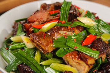 Preserved Duck Stir Fry with Scallions - Traditional Chinese Gourmet Dish on White Plate
