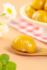 Sweet Glazed Chestnuts with Fresh Mint and Daisy Flowers on Wooden Spoon