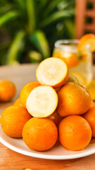 Fresh Kumquats with Cross Section on White Plate - Small Citrus Fruit with Sweet Edible Skin
