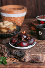 Fresh Guangxi Water Chestnuts Horseshoe Fruit on Rustic Wooden Table with Traditional Chinese Pottery