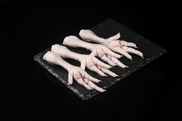 Fresh Raw Chicken Feet on Black Slate Board - Phoenix Claw Poultry Ingredient Display