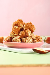 Crispy Fried Sesame Balls Guangxi Chinese Specialty Dessert on Pink Plate