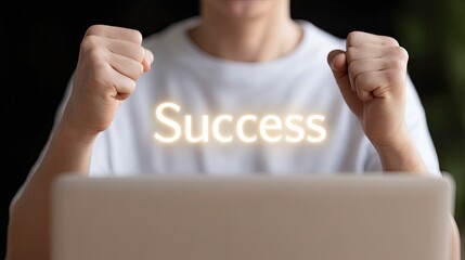 Closeup of young businessman raising fists in celebration of success, expressing joy and achievement while working on laptop. atmosphere is positive and motivating