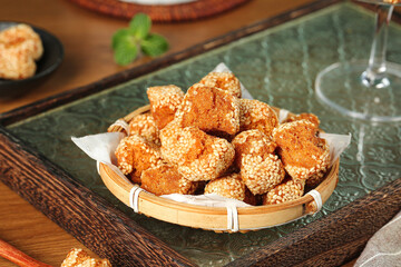 Traditional Guangxi Sesame Balls - Chinese Crispy Pastries with Sesame Coating in Bamboo Basket