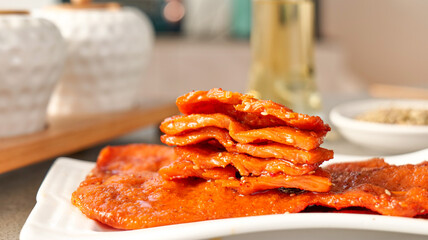 Fresh Grilled Bacon Strips Stacked on White Plate in Modern Kitchen - BBQ Breakfast Food Photography