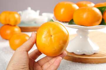 Fresh Fuping Persimmons from Shaanxi China - Sweet Crisp Alpine Fruit in Hand and Bowl Display