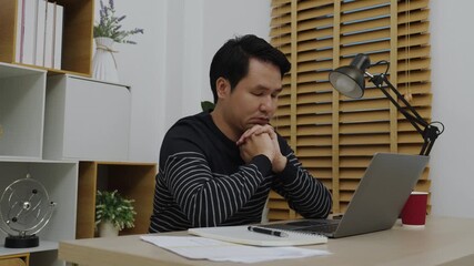 worried young man working with laptop computer at home office - Powered by Adobe