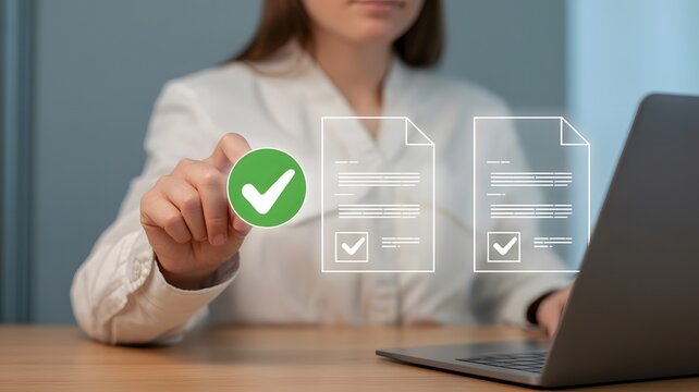 Businesswoman's hand confirming document on laptop. 