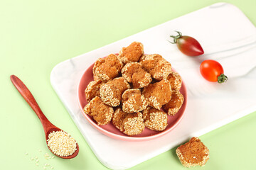 Deep-Fried Sesame Balls Chinese Pastries in Pink Bowl with Cherry Tomatoes Traditional Asian Food