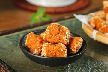 Crispy Sesame Balls Guangxi Traditional Chinese Snacks in Black Bowl on Wooden Table
