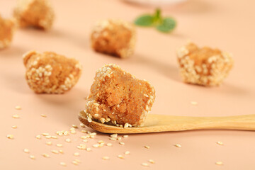 Crispy Hemp Balls Guangxi Chinese Specialty Snacks with Sesame Seeds on Wooden Spoon