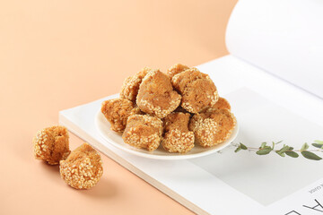 Golden Sesame Seed Balls Guangxi Chinese Traditional Snacks on White Plate Warm Background