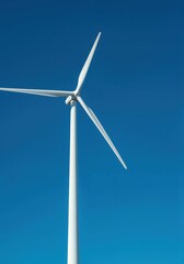Harnessing the Breeze: A singular wind turbine, a beacon of clean energy, stands tall against a clear, vivid blue canvas, a symbol of sustainability and renewable resources. 