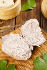 Whole Grain Steamed Buns Sliced on Bamboo Mat with Traditional Steamer Baskets