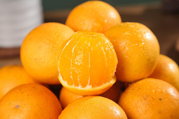Fresh Sweet Oranges with Peeled Fruit Showing Juicy Segments and Natural Citrus Texture