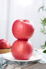 Fresh Red Apples Stacked on White Plate - Healthy Fruit Snack with Water Droplets